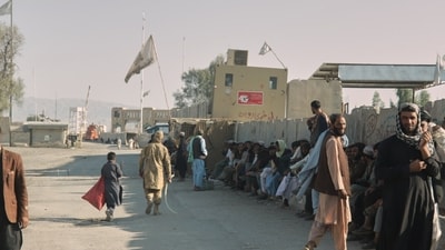 People wait near the closed gate at the Spin Boldak border crossing with Pakistan, after the border was shut for nearly two weeks following clashes between Afghan and Pakistani forces. (AP) People wait near the closed gate at the Spin Boldak border crossing with Pakistan, after the border was shut for nearly two weeks following clashes between Afghan and Pakistani forces. (AP)