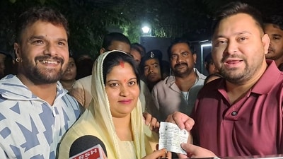 Singer and actor Khesari Lal Yadav, right, and his wife Chanda, with Tejashwi Yadav in Patna, Bihar,after he joined RJD. (PTI) Singer and actor Khesari Lal Yadav, right, and his wife Chanda, with Tejashwi Yadav in Patna, Bihar,after he joined RJD. (PTI)