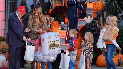 Trump and Melania welcomed families and handed out candy to trick-or-treaters during the annual Halloween celebration. (AP Photo/Jacquelyn Martin) (AP) Trump and Melania welcomed families and handed out candy to trick-or-treaters during the annual Halloween celebration. (AP Photo/Jacquelyn Martin) (AP)