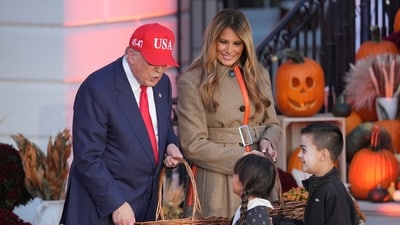 Trump, alongside Melania, handed out candy to children dressed as characters from The Addams Family, including a young girl in a Wednesday Addams costume. (AP Photo/Jacquelyn Martin) (AP) Trump, alongside Melania, handed out candy to children dressed as characters from The Addams Family, including a young girl in a Wednesday Addams costume. (AP Photo/Jacquelyn Martin) (AP)