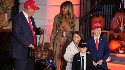 Trump, accompanied by Melania, handed out candy to children dressed as the first lady, a Secret Service agent, and even the president himself during the White House Halloween event. (AP Photo/Jacquelyn Martin) (AP) Trump, accompanied by Melania, handed out candy to children dressed as the first lady, a Secret Service agent, and even the president himself during the White House Halloween event. (AP Photo/Jacquelyn Martin) (AP)