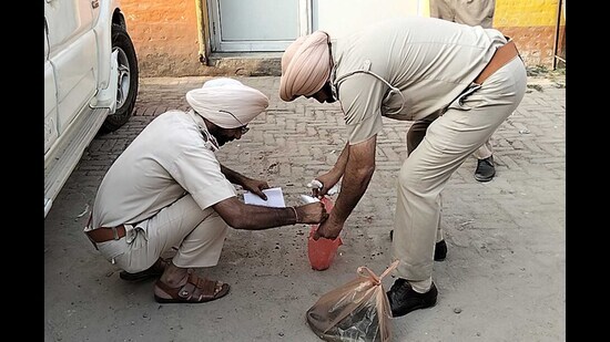 Police officials collecting evidence from the crime spot in Jagraon, Ludhiana, on Friday. (HT photo)