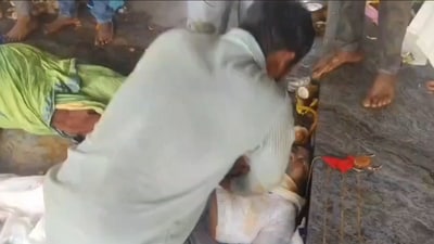 Screengrab of the video showing devotees helping people who fainted in the Andhra Pradesh temple stampede. Screengrab of the video showing devotees helping people who fainted in the Andhra Pradesh temple stampede.
