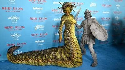 The Project Runway star's bright green, and pretty hideous, Medusa had several moving snakes protruding from her intricate headpiece, a snake-like tongue, and the costume, too, matched a snake's scales. (Instagram) The Project Runway star's bright green, and pretty hideous, Medusa had several moving snakes protruding from her intricate headpiece, a snake-like tongue, and the costume, too, matched a snake's scales. (Instagram)