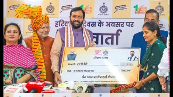 Haryana chief minister handing over a cheque to a beneficiary of the Lado Lakshmi Scheme on Saturday. (Source:X)