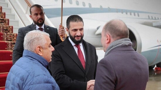 This handout photograph released by the official Syrian Arab News Agency (SANA) shows Syrian interim president Ahmed al-Sharaa (C) disembarking from a plane upon his arrival in Moscow on October 15, 2025. (AFP)