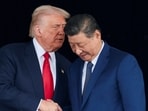 US President Donald Trump and Chinese President Xi Jinping talk as they leave after a bilateral meeting
