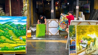 People clean paintings, following floods in central Vietnam that have killed several people, in Hoi An. (REUTERS)
