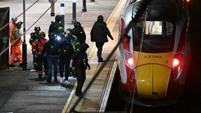 An older man "blocked" the attacker from stabbing a younger girl, leaving him with a gash on his head and neck, the witness said. (Justin Tallis/AFP) An older man "blocked" the attacker from stabbing a younger girl, leaving him with a gash on his head and neck, the witness said. (Justin Tallis/AFP)