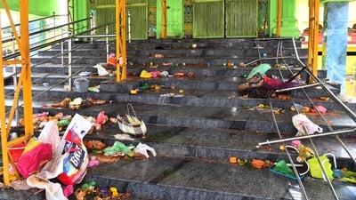 Personal belongings, food and other items lie on the stairs of Ventakeswara Swamy Temple after a stampede. (PTI) Personal belongings, food and other items lie on the stairs of Ventakeswara Swamy Temple after a stampede. (PTI)