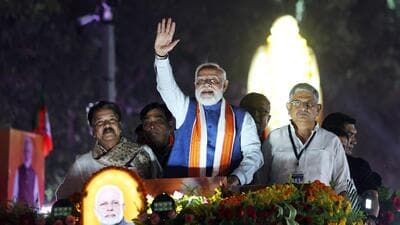 Prime Minister Narendra Modi waves during a roadshow for the Bihar assembly elections, in Patna on Sunday. (ANI) Prime Minister Narendra Modi waves during a roadshow for the Bihar assembly elections, in Patna on Sunday. (ANI)