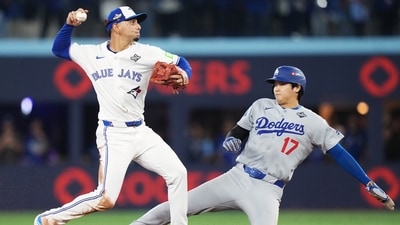 Toronto Blue Jays' Andrés Giménez, left, throws to first to turn a double play after forcing out Los Angeles Dodgers' Shohei Ohtani (17) at second during the seventh inning in Game 7 of baseball's World Series in Toronto on Saturday, Nov. 1, 2025. (AP) Toronto Blue Jays' Andrés Giménez, left, throws to first to turn a double play after forcing out Los Angeles Dodgers' Shohei Ohtani (17) at second during the seventh inning in Game 7 of baseball's World Series in Toronto on Saturday, Nov. 1, 2025. (AP)