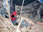 A Afghan Red Crescent rescue worker seen sifting through the destruction and rubble after a 6.3 earthquake struck Afghanistan's Balkh province on Monday(REUTERS)