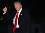 President Donald Trump gestures while walking across the South Lawn of the White House.