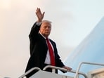 President Donald Trump waves as he boards Air Force One en route to Washington