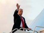 President Donald Trump waves as he boards Air Force One en route to Washington