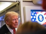 US President Donald Trump speaks to members of the press aboard Air Force One as he heads to Joint Base Andrews in Maryland.