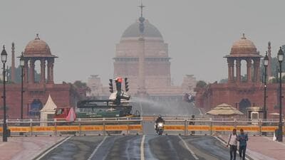 A vehicle sprays water droplets to reduce the effects of air pollution as a slight layer of smog is seen over Raisina Hills in New Delhi on Monday. (ANI) A vehicle sprays water droplets to reduce the effects of air pollution as a slight layer of smog is seen over Raisina Hills in New Delhi on Monday. (ANI)
