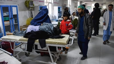 A burqa-clad woman sits beside an earthquake victim receiving treatment at a hospital in Mazar-i-Sharif. Monday morning's earthquake has left at least 320 people injured. (AFP) A burqa-clad woman sits beside an earthquake victim receiving treatment at a hospital in Mazar-i-Sharif. Monday morning's earthquake has left at least 320 people injured. (AFP)