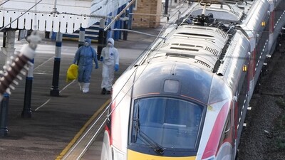 Forensic investigators walk on the platform at the train station after a mass stabbing on a London-bound train in Huntingdon, England, Sunday, (AP) Forensic investigators walk on the platform at the train station after a mass stabbing on a London-bound train in Huntingdon, England, Sunday, (AP)