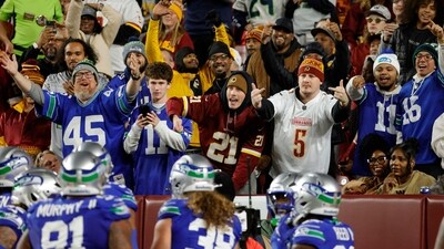 Seattle Seahawks and Washington Commanders fans react to a play during the first half at Northwest Stadium (IMAGN IMAGES via Reuters Connect)