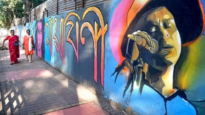 Women walk past a mural of late singer Zubeen Garg painted on a roadside wall in Guwahati on Monday, November 3, 2025. (PTI) Women walk past a mural of late singer Zubeen Garg painted on a roadside wall in Guwahati on Monday, November 3, 2025. (PTI)