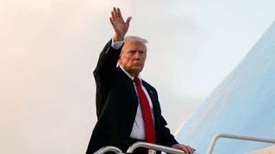 President Donald Trump waves as he boards Air Force One en route to Washington (REUTERS)