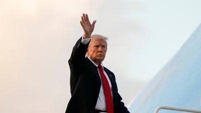 President Donald Trump waves as he boards Air Force One en route to Washington (REUTERS)