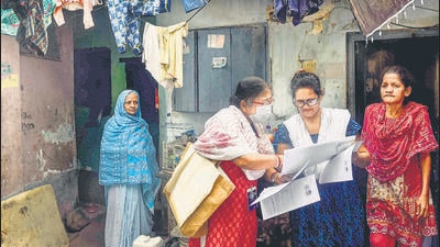 A booth level officer (BLO) speaks to residents in Kolkata on Tuesday. (PTI)