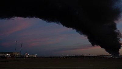 A plume of smoke wafts over airport property after reports of a plane crash at Louisville International Airport, Tuesday. (AP) A plume of smoke wafts over airport property after reports of a plane crash at Louisville International Airport, Tuesday. (AP)