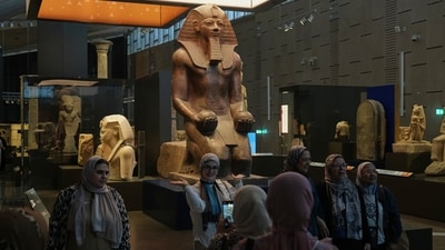Visitors pose for a group photo under the Hatshepsut statue at the Grand Egyptian Museum in Giza, Egypt. (AP Photo/Amr Nabil) Visitors pose for a group photo under the Hatshepsut statue at the Grand Egyptian Museum in Giza, Egypt. (AP Photo/Amr Nabil)