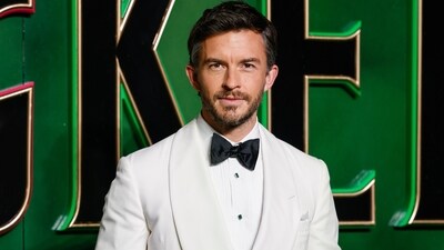 Bailey posed at the London Premiere of Wicked last year in a handsome white blazer, with a pleated white shirt underneath, and a sexy black bow tie. (AP)