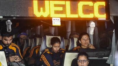 Richa Ghosh, right, and Amanjot Kaur seen as the bus carrying the Indian team arrives at IGI Airport, in New Delhi. (PTI)