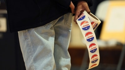 A poll worker holds "I Voted" stickers as people vote in the General Election at the P.S. 249 the Caton School on November 04, 2025 in the Flatbush neighborhood of the Brooklyn borough in New York City. (Getty Images via AFP) A poll worker holds "I Voted" stickers as people vote in the General Election at the P.S. 249 the Caton School on November 04, 2025 in the Flatbush neighborhood of the Brooklyn borough in New York City. (Getty Images via AFP)