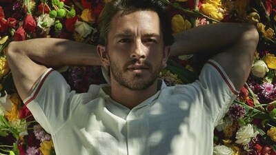 The Wicked actor stunned in a portrait from his photoshoot with Orlebar Brown, where he donned a light linen shirt with floral motifs, lying on a bed of flowers. (instagram/@jbayleaf)