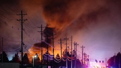 Plums of smoke rise from the area of a UPS cargo plane crash at Louisville Muhammad Ali International Airport, on Tuesday, Nov. 4, 2025, in Louisville, Ky. (AP Photo/Jon Cherry) (AP)