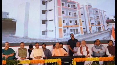 CM Yogi Adityanath and others during the event in Lucknow on Wednesday to distribute allotment letters to 72 EWS beneficiaries. (HT) CM Yogi Adityanath and others during the event in Lucknow on Wednesday to distribute allotment letters to 72 EWS beneficiaries. (HT)