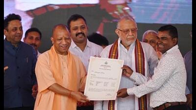 CM Yogi Adityanath handing over the allotment letter to a beneficiary during an event in Lucknow on Wednesday. (HT) CM Yogi Adityanath handing over the allotment letter to a beneficiary during an event in Lucknow on Wednesday. (HT)