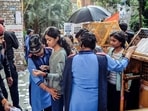  Guards check students as security gears up for JNU Student's Union elections, in New Delhi on Tuesday.