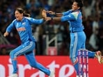India's captain Harmanpreet Kaur (L) and allrounder Deepti Sharma celebrate the dismissal of South Africa skipper Laura Wolvaardt in the ICC Women's Cricket World Cup final