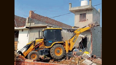 A house of a ‘drug smuggler’ being demolished in Kartar Nagar in Khanna on Thursday. (HT Photo)
