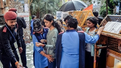 Guards check students as security gears up for JNU Student's Union elections, in New Delhi on Tuesday. (ANI Photo) Guards check students as security gears up for JNU Student's Union elections, in New Delhi on Tuesday. (ANI Photo)