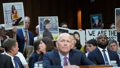 Photos of loved ones killed in Boeing 737 Max 8 plane crashes are held up as Boeing's CEO Dave Calhoun testifies before a Senate Homeland Security and Governmental Affairs Committee Investigations Subcommittee hearing on the safety culture at Boeing, on Capitol Hill in Washington, U.S., June 18, 2024. (REUTERS)