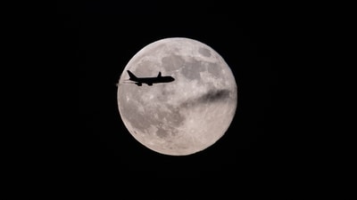 A UPS Boeing 747 inbound from Anchorage, Alaska passes in front of the moon (AP) A UPS Boeing 747 inbound from Anchorage, Alaska passes in front of the moon (AP)