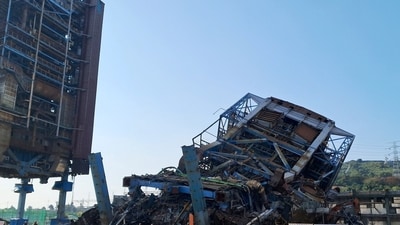 People walk near a large structure which collapsed and where multiple people are believed to be trapped, at the Korea East-West Power's Ulsan Power Plant headquarters, in Ulsan, South Korea, November 6, 2025. (via REUTERS)