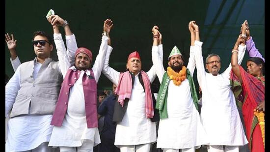 Samajwadi Party chief Akhilesh Yadav raises hands with INDIA bloc candidates during an election rally in support of the alliance’s candidates for the Bihar Assembly elections, in Bihar. (Handout via PTI Photo)