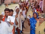 People wait for their turn to vote in Bihar.