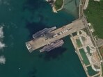 In this Oct. 8, 2025, satellite photo from Planet Labs PBC, the Chinese aircraft carriers Shandong and Fujian are seen at the Yulin Naval Base near Sanya, China. (Planet Labs PBC via AP)