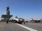 Crew members work on carrier-based aircraft from left, J-15T jet fighter, KJ-600 AWACS and J-35 stealth fighter jet on the flight deck of China's third conventionally powered aircraft carrier, the Fujian.