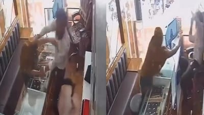 Acting upon his instant reflex, the shopkeeper dodged the attack and caught hold of her immediately. (Video grab/X) Acting upon his instant reflex, the shopkeeper dodged the attack and caught hold of her immediately. (Video grab/X)